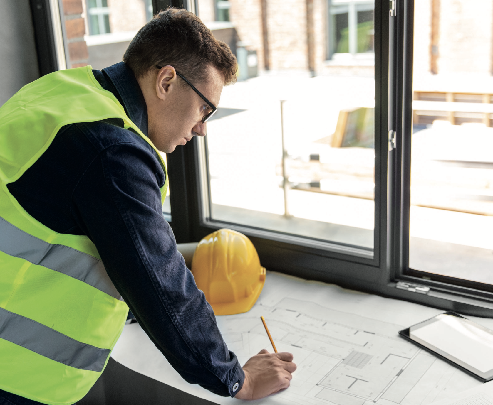 Project designer consulting plans within a building under construction - Principal Designer Building Safety Act