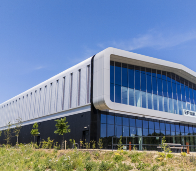 Large modern building with a blue sky and landscaping